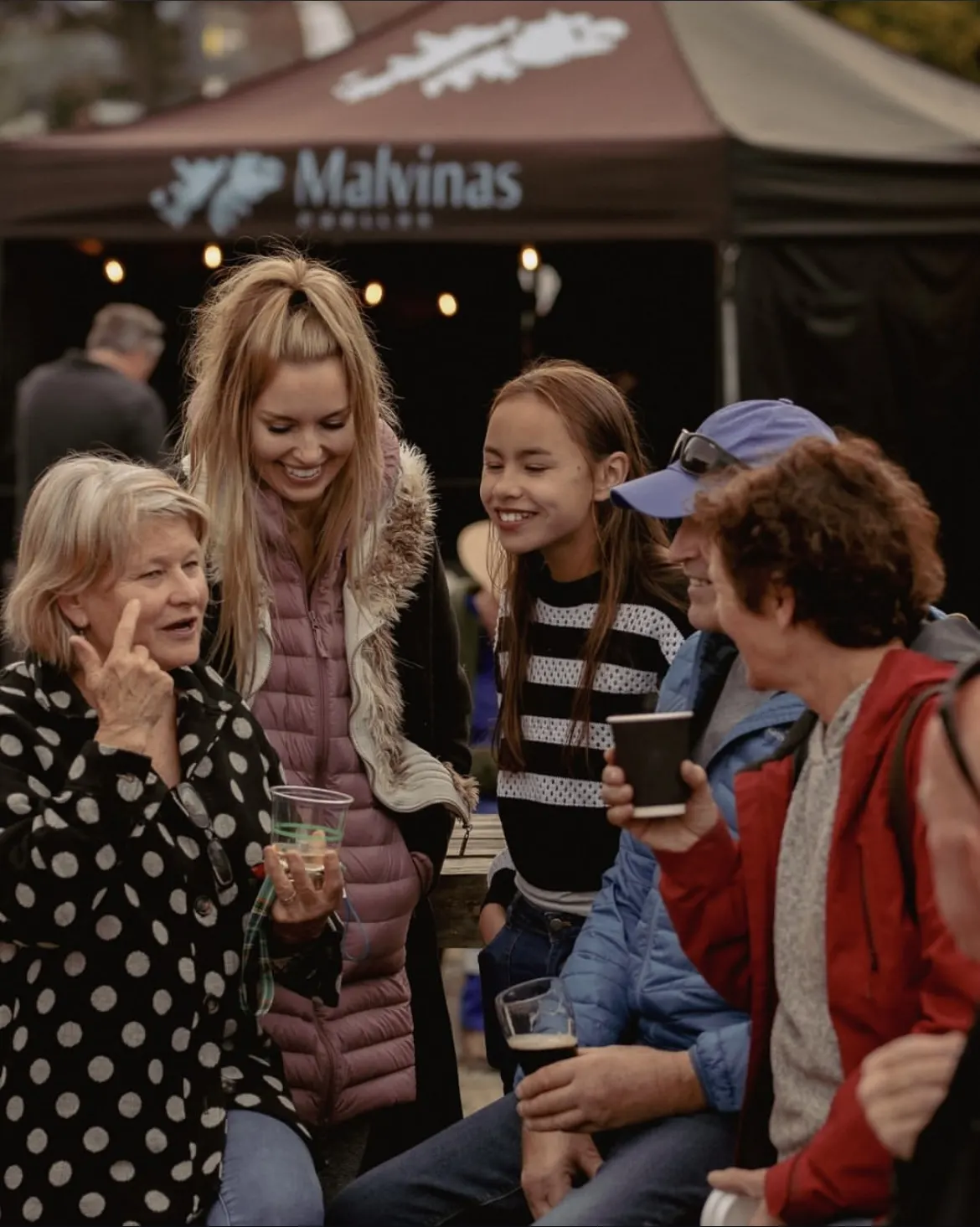 Families gathered at the Malvinas Paellas market stall